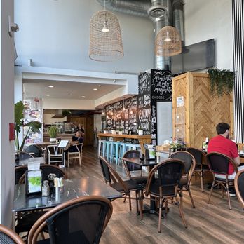 MIAM Cafe - a man sitting at a table - Breakfast & Brunch Near Me - Miami, Florida