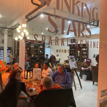 Winking Stars Sparkling Wines - a group of people sitting at a table - Wine Tasting Room Near Me - Anderson, Texas