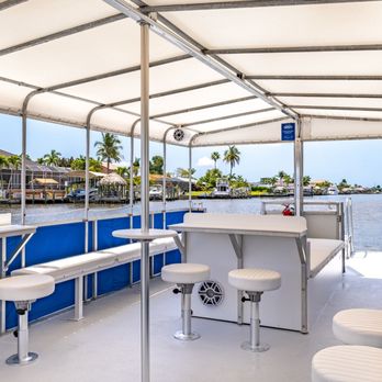 Off the Leash Charters - Lounge seating, tables and stools, a dedicated catering table, a Bluetooth sound system, decorative lighting, and even a restroom! - Boat Charters Near Me - Cape Coral, Florida Off the Leash Charters - Lounge seating, tables and stools, a dedicated catering table, a Bluetooth sound system, decorative lighting, and even a restroom! - Boat Charters Near Me - Cape Coral, Florida