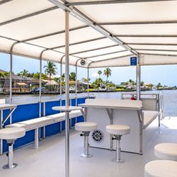 Off the Leash Charters - Lounge seating, tables and stools, a dedicated catering table, a Bluetooth sound system, decorative lighting, and even a restroom!