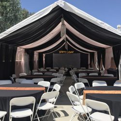 Jumpy Jumps Party Rentals - 2 Tone Pink/Black Draping
W/chandeliers 
Round tables 
Black linens w/gold runners