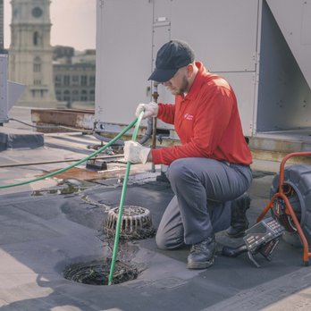 Zoom Drain - Technician power jetting stack lines from the roof of a commercial building. Stack, Snake, Roof, Drains - Plumbing Near Me - Stamford, Connecticut