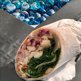 Half of a Asian Chicken wrap, close to the fire pit