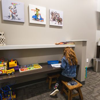 Royal Oak Optometry - Photograph of a young child at play in the waiting area at Royal Oak Optometry. - Eyewear & Opticians Near Me - Victoria, British Columbia