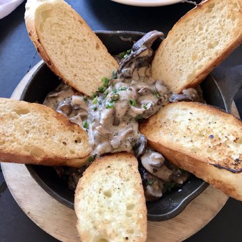 Mom's Kitchen & Bar - Dropkick Mushrooms- Seared shitake, oyster and cremini mushrooms in a truffle mascarpone cream sauce with onion crostini - Bars Near Me - Astoria, New York Mom's Kitchen & Bar - Dropkick Mushrooms- Seared shitake, oyster and cremini mushrooms in a truffle mascarpone cream sauce with onion crostini - Bars Near Me - Astoria, New York