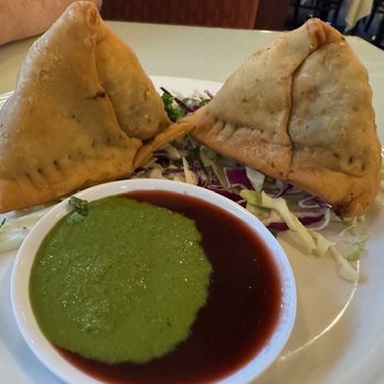 Saffron Grill - 2 Beef Samosas accompanied with a bed of shredded cabbage and 2 sauces - Indian Near Me - Seattle, Washington Saffron Grill - 2 Beef Samosas accompanied with a bed of shredded cabbage and 2 sauces - Indian Near Me - Seattle, Washington