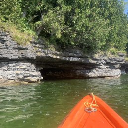 Paddling along Lake Michigan shores of Door Country toward the cave entry