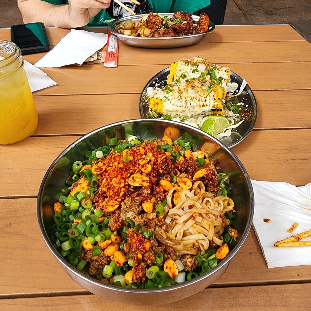 Spork - Dan Dan Noodles (front), elote (center), and fried chicken. - Mexican Near Me - Bend, Oregon Spork - Dan Dan Noodles (front), elote (center), and fried chicken. - Mexican Near Me - Bend, Oregon