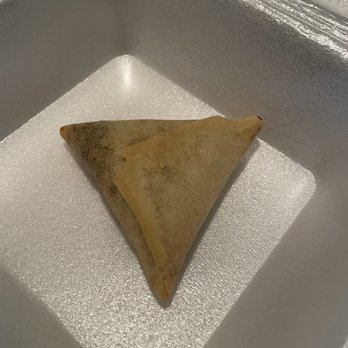 Palm India Restaurant - a triangular pastry in a container - Indian Near Me - Carrollton, Texas