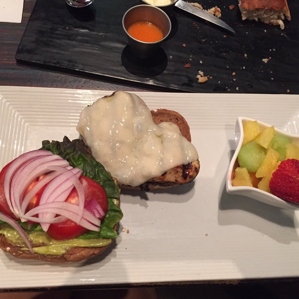 Sisserou's Caribbean Restaurant & Catering - Jerk chicken sandwich with a cup of fruit - Caribbean Near Me - Tulsa, Oklahoma