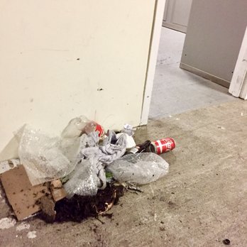 Garrison Square - A pile of trash on the floor in the garage on the way to where you pick up your packages. - Apartments Near Me - Boston, Massachusetts