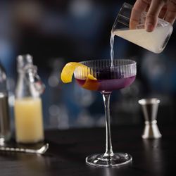 Eddie V's Prime Seafood - Our signature Hope Diamond Cocktail, featuring Grey Goose vodka, butterfly tea and a purple diamond ice cube