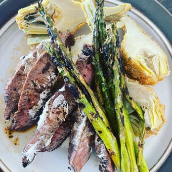 Nola's - a plate of steak, asparagus, and bread - New American Near Me - Clinton, New York