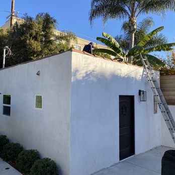 CID Builders & Developers - a man on the roof of a house - General Contractors Near Me