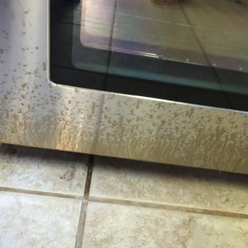 911 Carpet & Stone Care - Brand new stainless stove after David cleaned our tile floor. The treatment and lack of cleaning his mess up has caused pitting/staining. - Carpet Cleaning Near Me