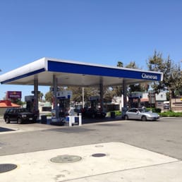 a gas station with cars parked in front of it