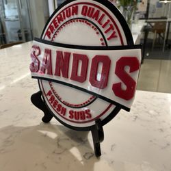 Sandos - Cute sign. We like to sit at this marble counter.