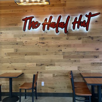 Halal Hut - tables and chairs in front of a wood paneled wall - Halal Near Me - Centereach, New York