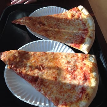 Uncle Joe's Pizza & Subs - Two slices. Notice the size compared to the normal sized plates....insanity! - Pizza Near Me - Pittston, Pennsylvania
