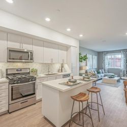 LIVIA at Scripps Ranch - Pacific Plan (2 BR, 2BA) Open concept floor plan with white shaker cabinetry, designer mosaic backsplash, and stainless-steel appliances.