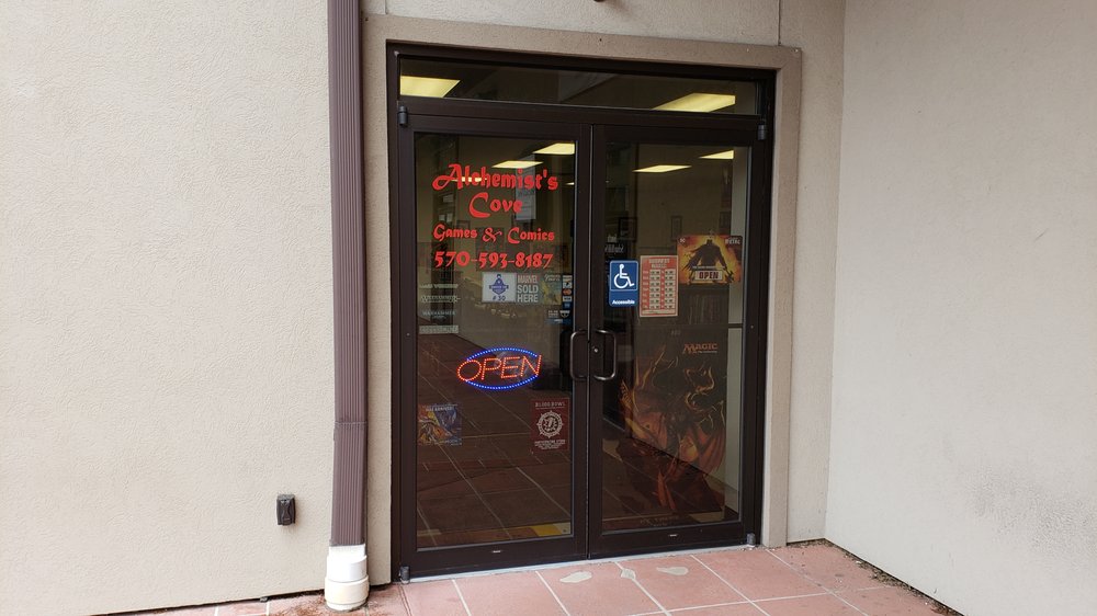 Alchemist's Cove Games & Comics Logo