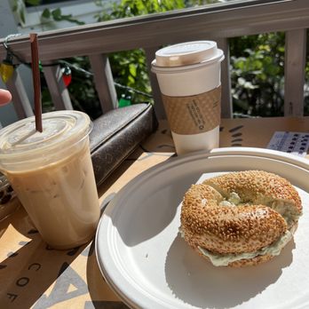 Sanibel Bean - A bagel on a plate with two coffee drinks - Coffee & Tea Near Me - Sanibel, Florida Sanibel Bean - A bagel on a plate with two coffee drinks - Coffee & Tea Near Me - Sanibel, Florida