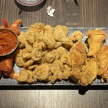 The Spot - Spot appetizer sampler - mozzarella sticks, shrimp kisses, fried pickles, lemon pepper wings, and onion rings. - Burgers Near Me - League City, Texas The Spot - Spot appetizer sampler - mozzarella sticks, shrimp kisses, fried pickles, lemon pepper wings, and onion rings. - Burgers Near Me - League City, Texas