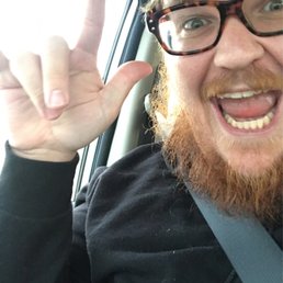a man in a car making a peace sign