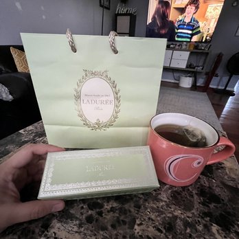 Laduree - a person holding a cup of coffee - Macarons Near Me - Bethesda, Maryland Laduree - a person holding a cup of coffee - Macarons Near Me - Bethesda, Maryland