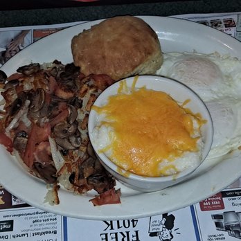 Metro Diner - This is a picture of hash browns with tomatoes and mushrooms eggs lightly over with cheese grits in a Biscuit - Breakfast & Brunch Near Me - Jacksonville, Florida