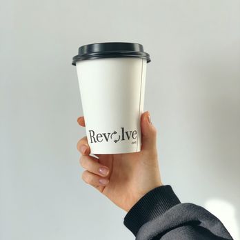 Revolve Cafe - a hand holding a coffee cup - Cafes Near Me - Saskatoon, Saskatchewan Revolve Cafe - a hand holding a coffee cup - Cafes Near Me - Saskatoon, Saskatchewan
