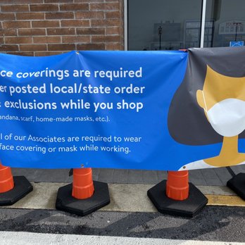 Walmart - a blue sign with a face coverings are required - Department Stores Near Me - Delaware, Ohio