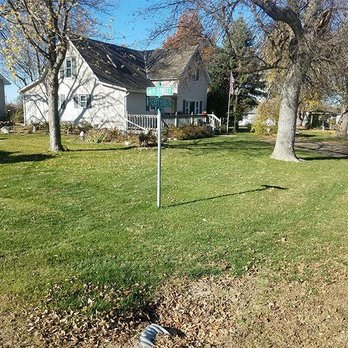 Mosley Yardworks - a street sign in front of a house - Landscaping Near Me - Lincoln, Nebraska