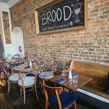 Brood Restaurant and Bar - The interior sign of the restaurant is a framed blackboard that hangs on one of the brick walls. - Desserts Near Me - Salem, Virginia