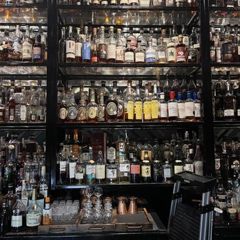 Whiskeys - shelves of liquor bottles and liquor glasses - Whiskey Bars Near Me - Dallas, Texas Whiskeys - shelves of liquor bottles and liquor glasses - Whiskey Bars Near Me - Dallas, Texas
