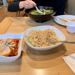 a woman eating a bowl of noodles a woman eating a bowl of noodles