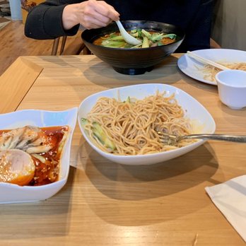Tian Fu Old Town - a woman eating a bowl of noodles - Chinese Near Me - Seattle, Washington Tian Fu Old Town - a woman eating a bowl of noodles - Chinese Near Me - Seattle, Washington