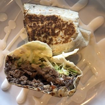 Tequila Comida & Cantina - Brisket Burrito with a crema sauce - Mexican Near Me - Wilmington, North Carolina Tequila Comida & Cantina - Brisket Burrito with a crema sauce - Mexican Near Me - Wilmington, North Carolina