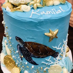 Three tier vanilla cake with strawberry whipped cream filling. Butter cream frosting. Sea turtle ocean theme cake. Three tier vanilla cake with strawberry whipped cream filling. Butter cream frosting. Sea turtle ocean theme cake.