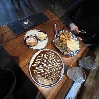 Perla - Enchiladas de mole, beans, rice... stake and eggs but they didn't have the regular stake so they gave him different meat. - Tapas/Small Plates Near Me - Santa Ana, California