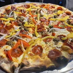 Pizza with sausage, pepperoni, onions, and peppers