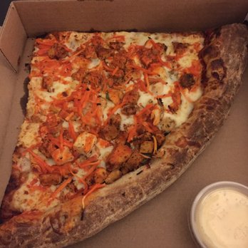 Lighthouse Pizza - 9in pie slice with honey wheat, red sauce, chicken, spicy chicken, carrots, spinach, and buffalo drizzle - Pizza Near Me - Omaha, Nebraska