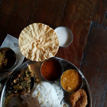 Southern Spice - Lunch thali - rice in the center and various curries along the outside of the plate - Yes I'm eating with my hands - you should too! - Indian Near Me - Irving, Texas