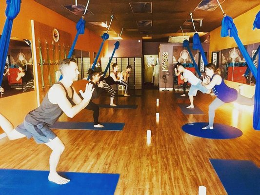 Aerial Yoga - Aerial yoga is a dynamic fusion of traditional yoga and acrobatics, performed suspended from a soft hammock or silk sling. It enhances flexibility, strength, and balance while adding an element of playfulness and gravity-defying fun to your practice. Aerial Yoga - Aerial yoga is a dynamic fusion of traditional yoga and acrobatics, performed suspended from a soft hammock or silk sling. It enhances flexibility, strength, and balance while adding an element of playfulness and gravity-defying fun to your practice.