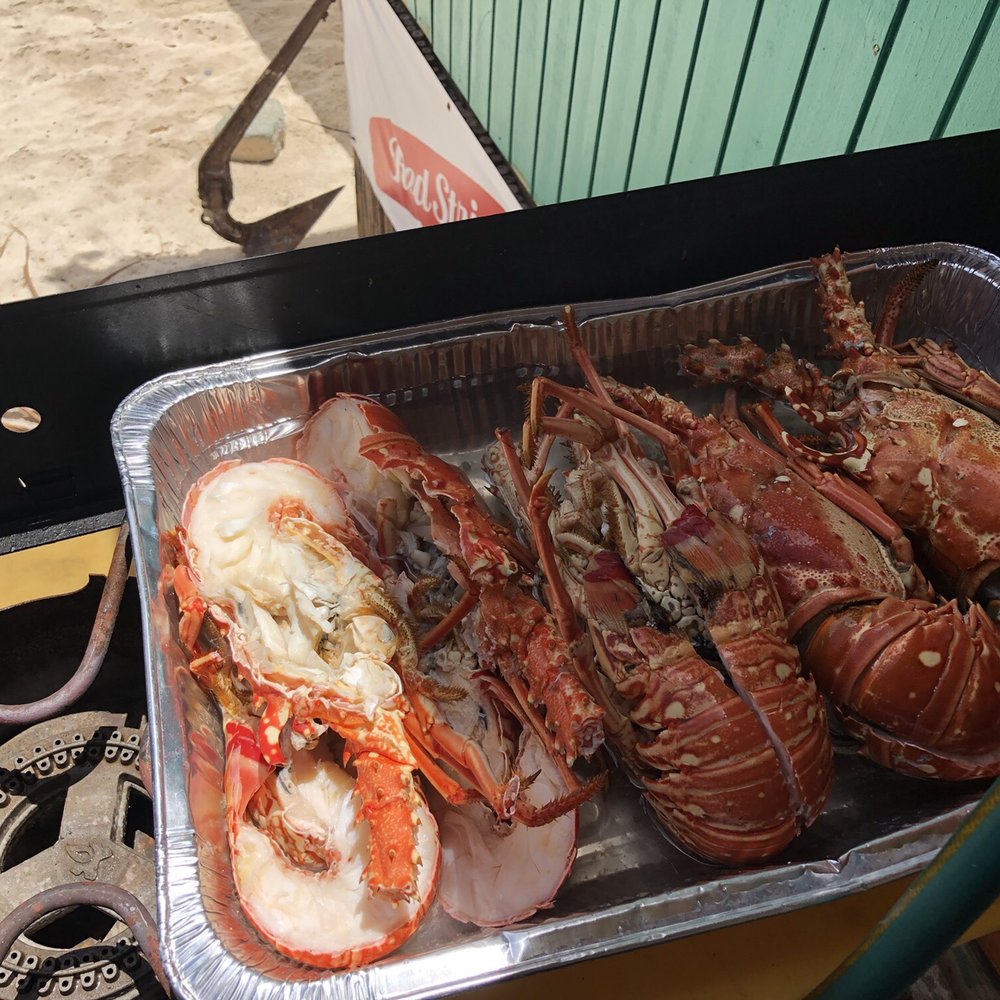 Coki Beach - Chef preparing fresh grilled Caribbean Lobster. Yum!! - Beaches Near Me - St Thomas, Virgin Islands Coki Beach - Chef preparing fresh grilled Caribbean Lobster. Yum!! - Beaches Near Me - St Thomas, Virgin Islands