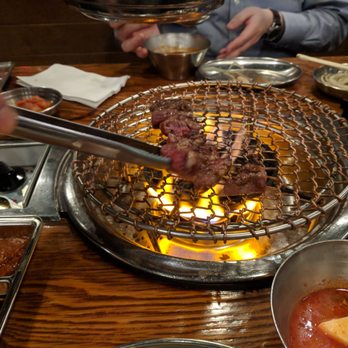 Jongro BBQ - A restaurant staff cooking the meat ordered - Korean Near Me - New York, New York Jongro BBQ - A restaurant staff cooking the meat ordered - Korean Near Me - New York, New York