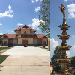 Sri Guruvayurappan Temple - The main temple and the multi tiered brass lamp with a figure if Garuda on top