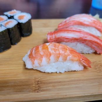Sushi AI - three pieces of sushi on a cutting board - Sushi Bars Near Me - Kalamazoo, Michigan Sushi AI - three pieces of sushi on a cutting board - Sushi Bars Near Me - Kalamazoo, Michigan