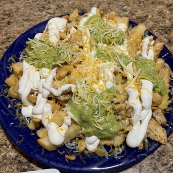 Burrito Grande - a plate of nachos and a bowl of guacamole - Mexican Near Me - Roy, Utah Burrito Grande - a plate of nachos and a bowl of guacamole - Mexican Near Me - Roy, Utah