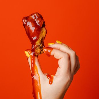 Wings Over Worcester - a hand holding a piece of food - Chicken Wings Near Me - Worcester, Massachusetts Wings Over Worcester - a hand holding a piece of food - Chicken Wings Near Me - Worcester, Massachusetts